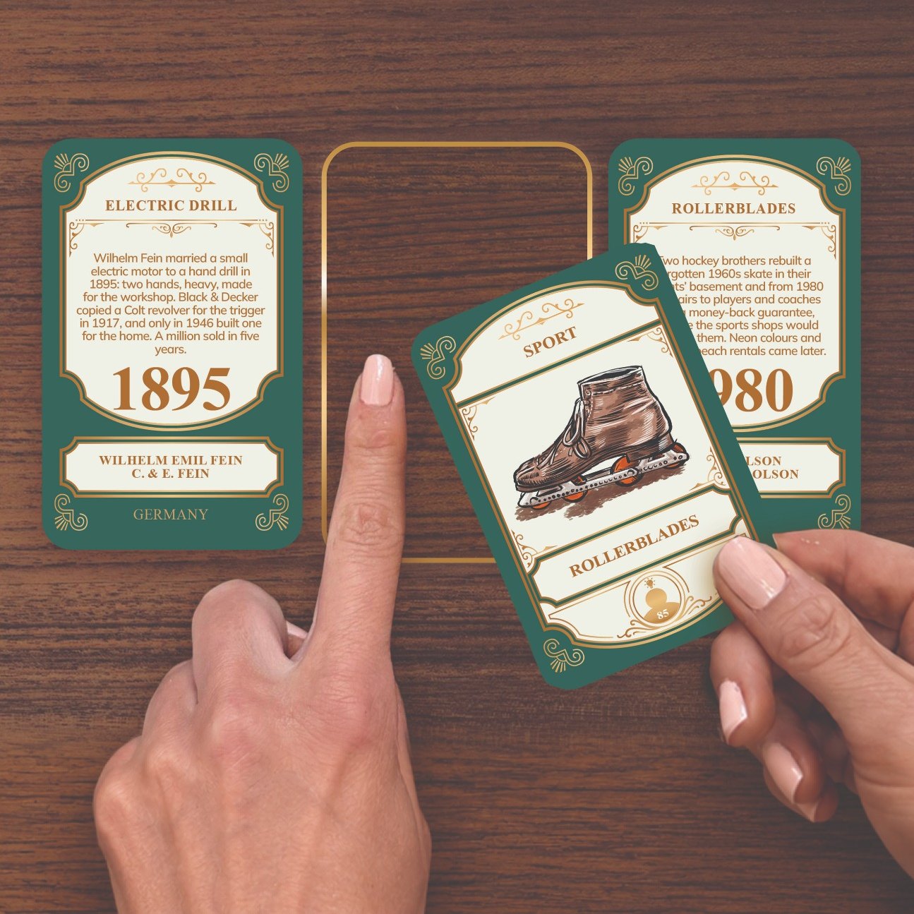 A hand lowering the Rollerblades card into the gap between two cards already on the table
